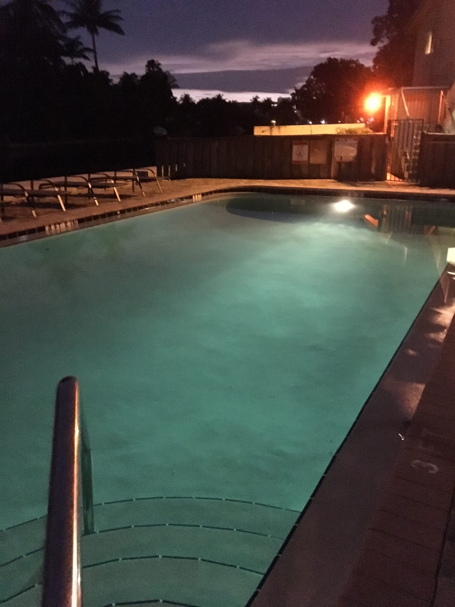 Image of Three Rivers East Condos pool at dusk with pool light on.